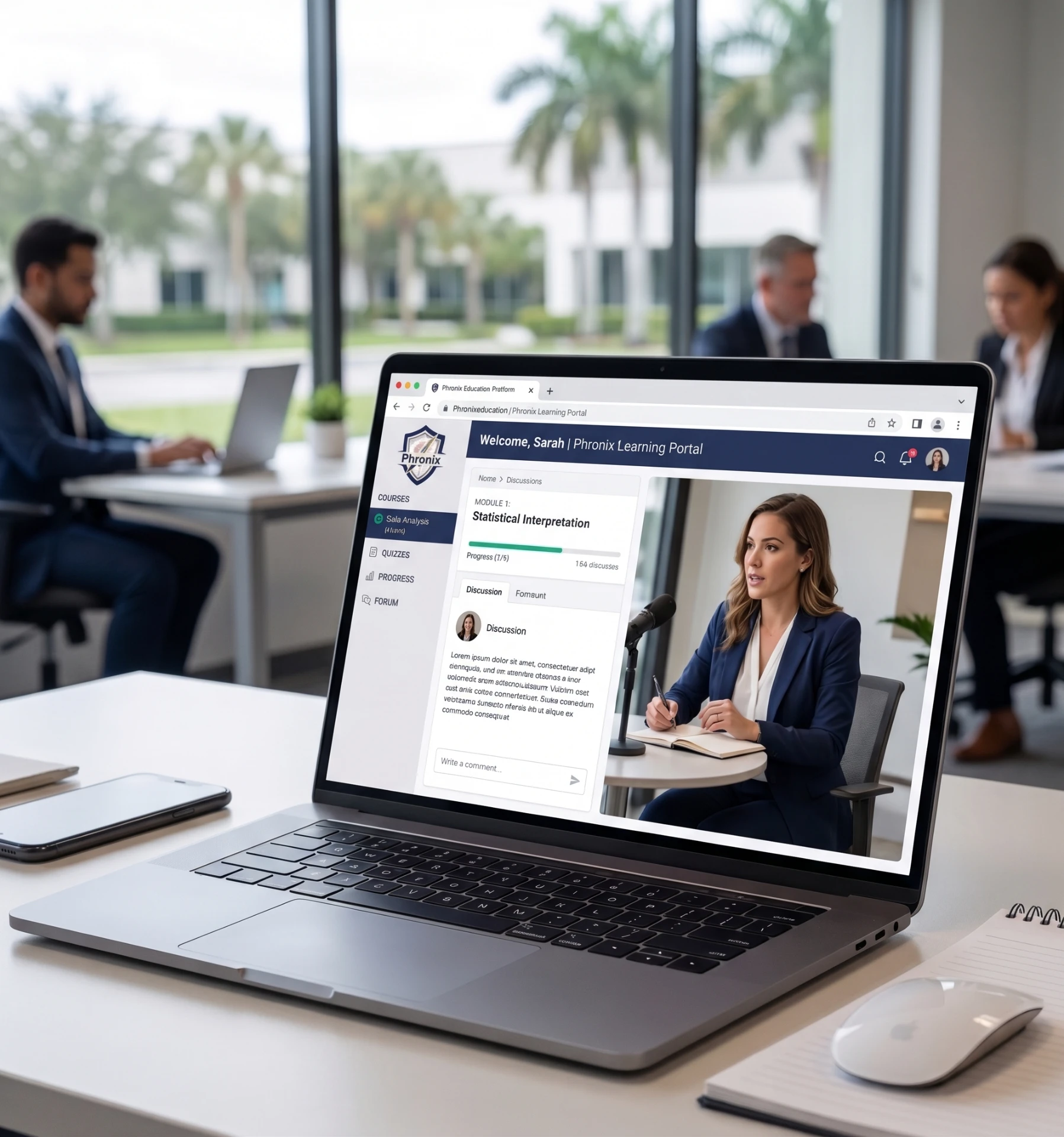 Phronix learning portal shown on a laptop in a modern office